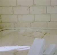 Liegt das Rohr direkt an der Außenwand, so ist es unmöglich, den Innenputz bis auf die Rohdecke zu ziehen. Es bleibt ein unverputzter Streifen, die Luftdichtheit ist nicht garantiert. Abhilfe: Das Rohr mit Abstand zur Außenwand verlegen. (Quelle: Niedrig Energie Institut)